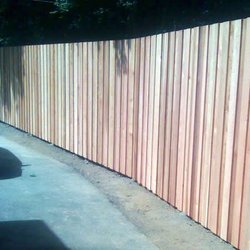Embassy Enterprises - This is a 7' tall overlap privacy fence with dog eared top fence boards.