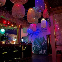 the interior of a tropical themed bar