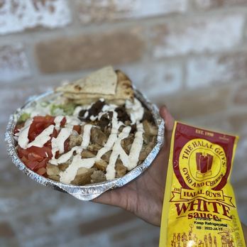 The Halal Guys - a hand holding a bowl of food - Middle Eastern Near Me - Houston, Texas The Halal Guys - a hand holding a bowl of food - Middle Eastern Near Me - Houston, Texas