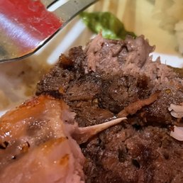 a plate of meat and rice