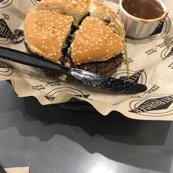 Fatburger - a half eaten hamburger with a fork and dipping sauce - Burgers Near Me - Spruce Grove, Alberta Fatburger - a half eaten hamburger with a fork and dipping sauce - Burgers Near Me - Spruce Grove, Alberta