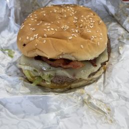 a cheeseburger wrapped in aluminum foil a cheeseburger wrapped in aluminum foil