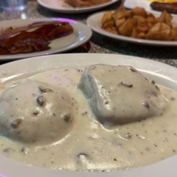 Breakfast Brunch - Close up is biscuits and sausage gravy. See? Specks of sausage. Overall flavor is good though. - Breakfast & Brunch Near Me - Greensboro, North Carolina