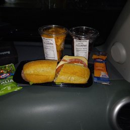 a tray of sandwiches and chips on a car seat a tray of sandwiches and chips on a car seat