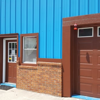 Screen Warehouse USA - two garage doors and a brick wall - General Contractors Near Me - Lees Summit, Missouri
