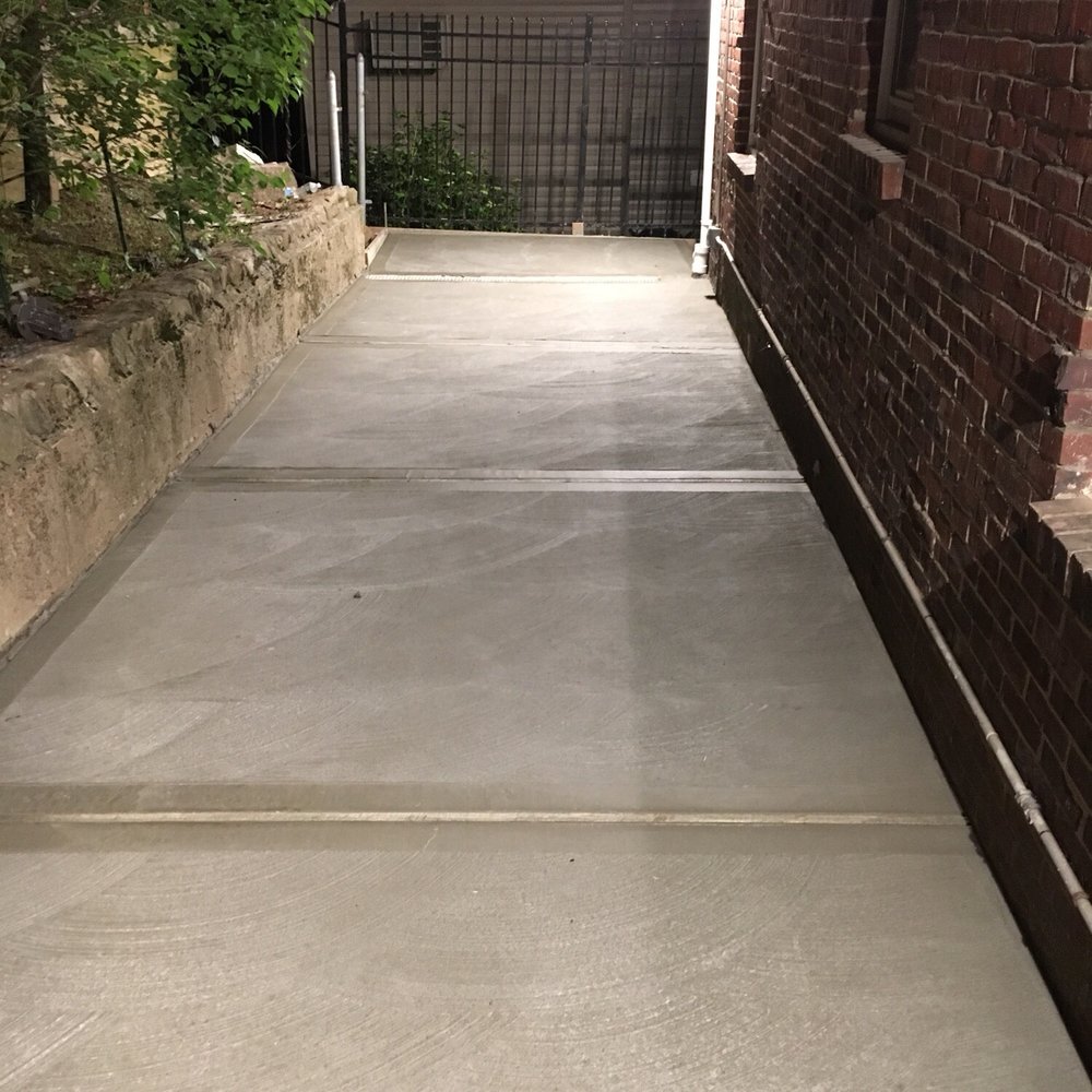 Mr Brickman - Backyard patio concrete with zipper drains and pipes leading rainfall out to front, away from house. - General Contractors Near Me - Staten Island, New York Mr Brickman - Backyard patio concrete with zipper drains and pipes leading rainfall out to front, away from house. - General Contractors Near Me - Staten Island, New York