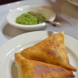 Queen Sheba Ethiopian Restaurant & Bar - Name escapes me, but it's a pastry filled w/spicy beef w/a side of spicy green stuff to top it with. it was good! (appetizer)