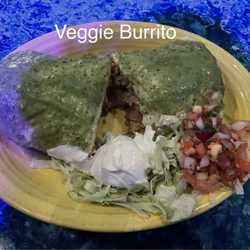 Veggie Burrito (vegetarian) with green tomatillo sauce.  Other sauces available. Filled with zucchini, rice, beans.  Large enough to share.