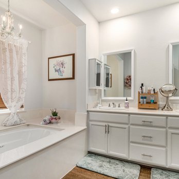 Curbio - a bathroom with a tub, sink, and mirror - General Contractors Near Me - Potomac, Maryland