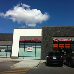 the outside of a restaurant with cars parked in front of it the outside of a restaurant with cars parked in front of it