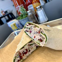 Rowdy Rooster - Chicken Salad Wrap. Roasted Chicken, Dried Cranberries, Red Onion, Celery, Toasted Pecans, and Granny Smith Apple!!! It's so YUMMY!!!