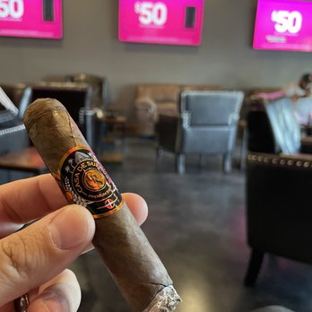 Ron'devu Cigar Lounge - a hand holding a cigar - Cigar Bars Near Me - Menifee, California