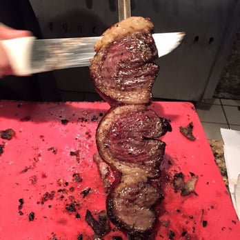 Beef Grill - Picanha (top sirloin cap or coulotte) being sliced. - Brazilian Near Me - Sandy Springs, Georgia