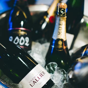 Pinocchio - several bottles of champagne in a bucket - French Near Me - Magog, Quebec Pinocchio - several bottles of champagne in a bucket - French Near Me - Magog, Quebec