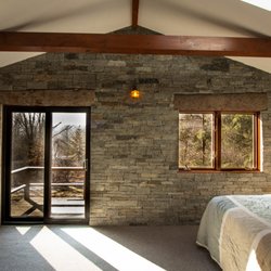Eddie's Yard - Blue Mountain veneer on this indoor bedroom wall. Masonry Design / Build