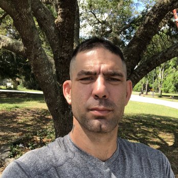Sharp Cut Lawn - a man holding a frisbee - Lawn Services Near Me