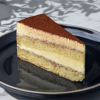 Sweet Cafe - Tiramisu Cake
Delicate layers of tiramisu cake and whipped cream, served in a glass with a light sprinkle of cocoa and chocolate shavi - Desserts Near Me - Van Nuys, California Sweet Cafe - Tiramisu Cake
Delicate layers of tiramisu cake and whipped cream, served in a glass with a light sprinkle of cocoa and chocolate shavi - Desserts Near Me - Van Nuys, California