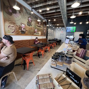 Mozna Chocolate And Coffee - Seating near the counter and chocolates at the counter. - Chocolatiers & Shops Near Me - San Antonio, Texas Mozna Chocolate And Coffee - Seating near the counter and chocolates at the counter. - Chocolatiers & Shops Near Me - San Antonio, Texas