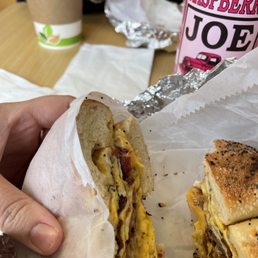 a person holding a sandwich