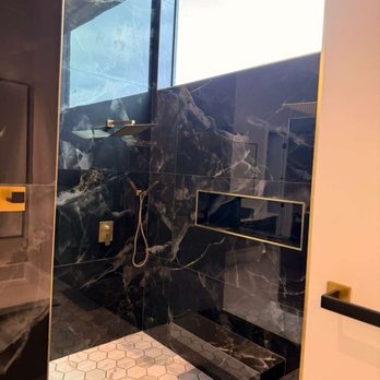 Raging Bull Contracting - High-end walk-in shower remodel with black marble-look tile, gold shower fixtures, recessed niche, and frameless glass. Raging Bull - General Contractors Near Me - San Antonio, Texas Raging Bull Contracting - High-end walk-in shower remodel with black marble-look tile, gold shower fixtures, recessed niche, and frameless glass. Raging Bull - General Contractors Near Me - San Antonio, Texas