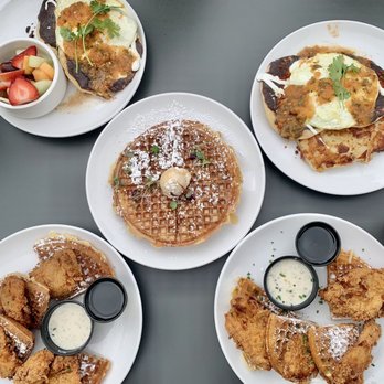Poached Kitchen - Chicken and waffles x2, churro waffles, huevos rancheros (1 with a side of fruit, the other with a side of potato hash) - Breakfast & Brunch Near Me - Irvine, California