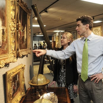 Brunk Auctions - Company President and CEO, Andrew Brunk with Tennessee Director of Operations, Sarah Sperling viewing a painting in the gallery. - Auction Houses Near Me - Asheville, North Carolina