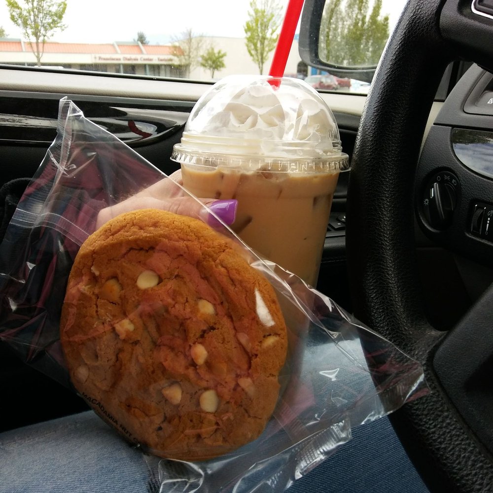 a cookie and a drink in a car a cookie and a drink in a car