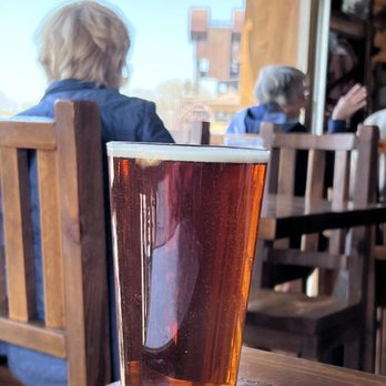Two Rivers Lodge Bar & Grill - On tap!  Rum River Amber (20 oz for $6) with the BNSF Railroad Lift Bridge in background - American Near Me - Prescott, Wisconsin