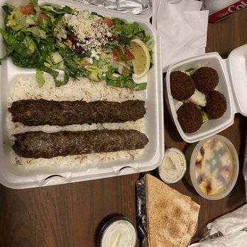 Nadia's Mediterranean Grill - Kofta plate with sides of falafel and hummus. (The lid is still on the hummus.) - Mediterranean Near Me - Spring, Texas Nadia's Mediterranean Grill - Kofta plate with sides of falafel and hummus. (The lid is still on the hummus.) - Mediterranean Near Me - Spring, Texas