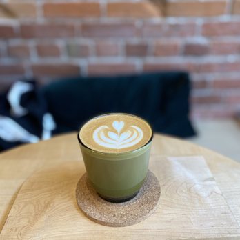 Saint Cecilia - a cup of coffee on a wooden table - Coffee & Tea Near Me - Victoria, British Columbia