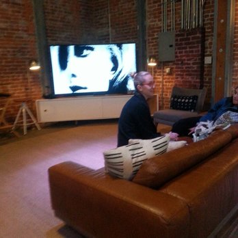 Microsoft Lounge - a man and a woman sitting on a couch in front of a television - Lounges Near Me - Los Angeles, California Microsoft Lounge - a man and a woman sitting on a couch in front of a television - Lounges Near Me - Los Angeles, California