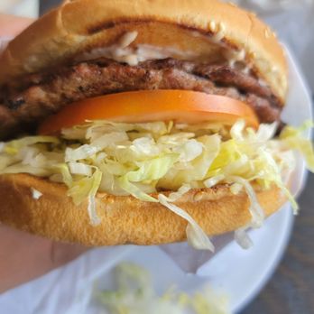 Husky Boy Restaurant - a hand holding a large sandwich - Burgers Near Me - Santa Ana, California Husky Boy Restaurant - a hand holding a large sandwich - Burgers Near Me - Santa Ana, California