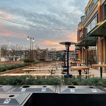 Belmont Hall - a row of trash bins in front of a building - Sports Bars Near Me - Elmont, New York