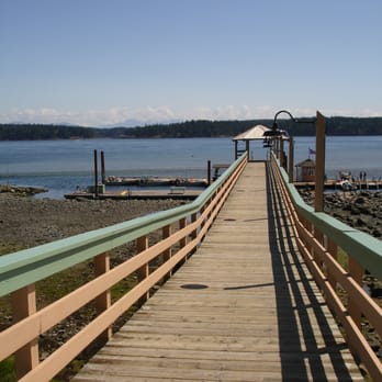 Painter's Lodge - View down pier to private dock, where free ferry and fishing boats come and go. - Hotels Near Me - Campbell River, British Columbia