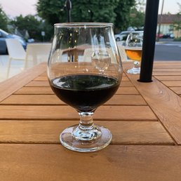 a glass of wine on a wooden table