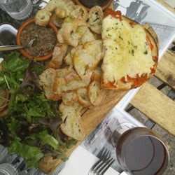 Bella Socca - One of the two plates in Assortment Traditionale: bruschetta, green and black olive and anchovies puree, bread and greens.