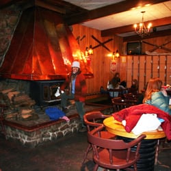 Ice Chalet - Warm up by the cozy fireplace.