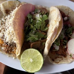 Left to right: chicken mole, lengua, al pastor tacos. Left to right: chicken mole, lengua, al pastor tacos.