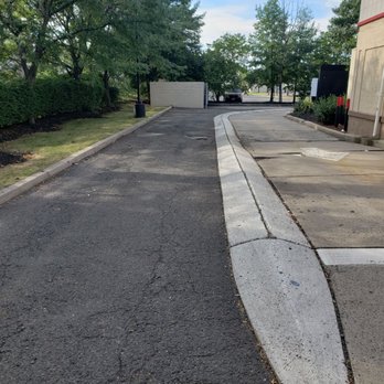 KFC - More pot holes on way out of property. - Chicken Wings Near Me - Iselin, New Jersey