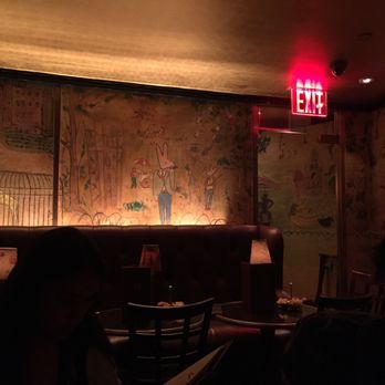 Bemelmans Bar - a man sitting at a table - Cocktail Bars Near Me - New York, New York