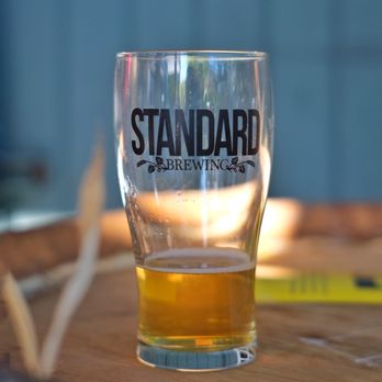 Standard Brewing - a glass of beer on a table - Breweries Near Me - Seattle, Washington