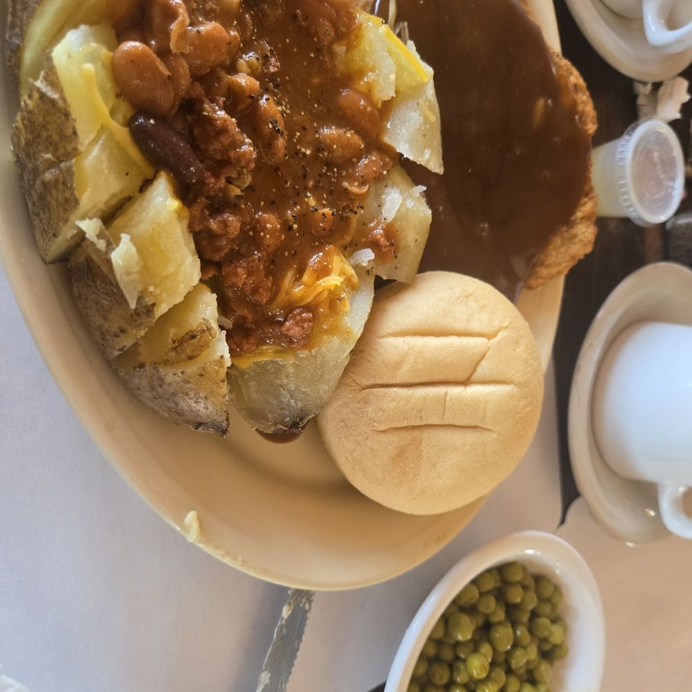 Blue Coffee Pot Restaurant - Chicken fried steak with brown gravy, baked potato, peas, and a roll. - Diners Near Me - Kayenta, Arizona Blue Coffee Pot Restaurant - Chicken fried steak with brown gravy, baked potato, peas, and a roll. - Diners Near Me - Kayenta, Arizona