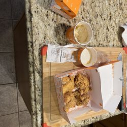 Popeyes Louisiana Kitchen - This is a $75 dollar yelp order. 4 bites of MacNCheese. Not a single breast in the box. All wings and thighs. A complete rip off.