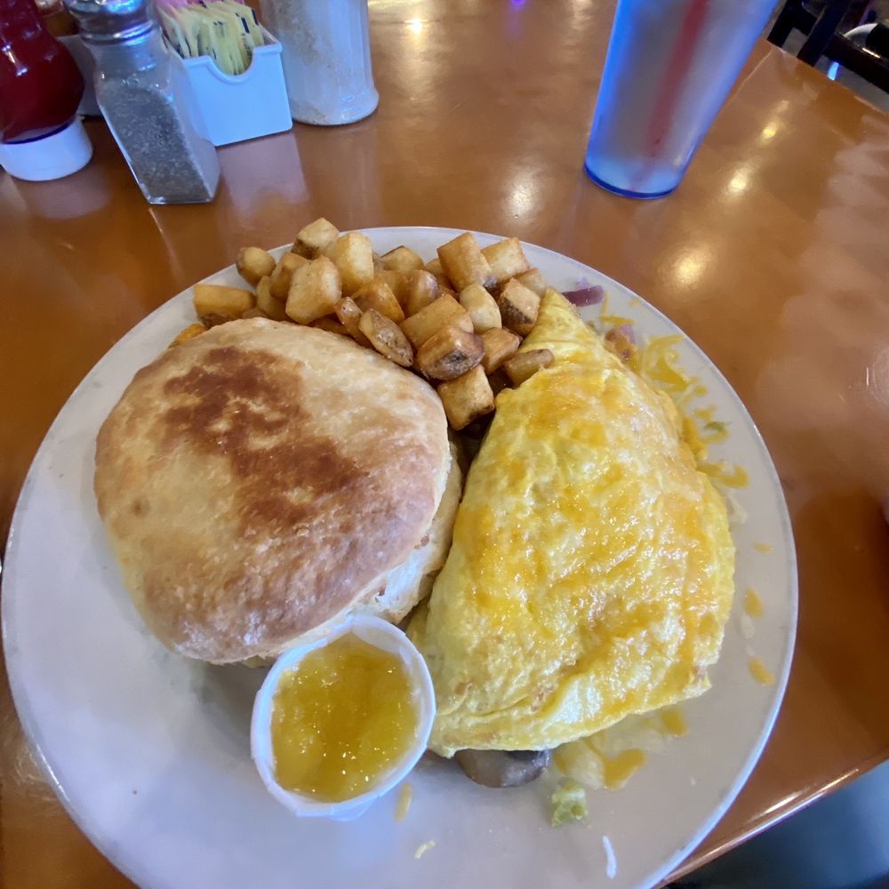 Mona Lisa 2-egg omelette with home fries and griddle biscuit. Mona Lisa 2-egg omelette with home fries and griddle biscuit.