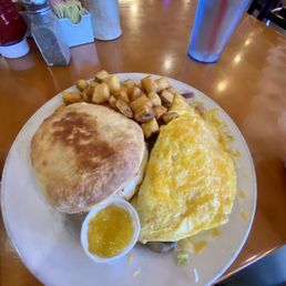 Mona Lisa 2-egg omelette with home fries and griddle biscuit. Mona Lisa 2-egg omelette with home fries and griddle biscuit.