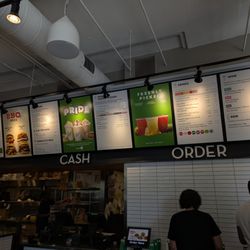 Inside. Self-serve order tablets, cash counter, and menu above. See my close-ups of the menu for better readability.