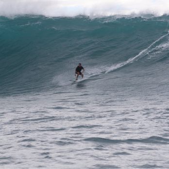 Jamie Sterling - Tow in session at an outer reef on the north shore - Surf Schools Near Me