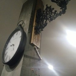 Historya by Antigo - Old antique clock and a cast-iron lamp holder