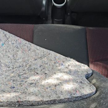 Victory Mitsubishi - Damaged cargo and spare tire cover with a filthy back seat. - Car Dealers Near Me - Bronx, New York