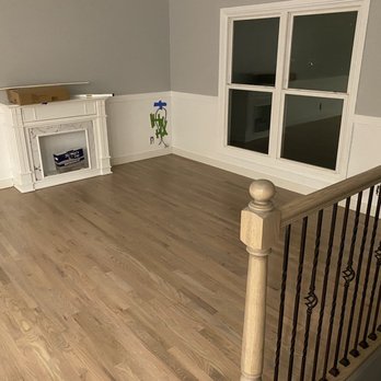 EMC Floors - a living room with a fireplace and stairs - Flooring Near Me - Elgin, Illinois